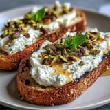 Creamy whipped ricotta toast with honey and pistachios, golden toasted bread awaits.