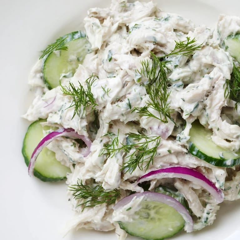Vibrant creamy cucumber chicken salad topped with chopped green onions, served chilled and ready for a refreshing summer lunch.