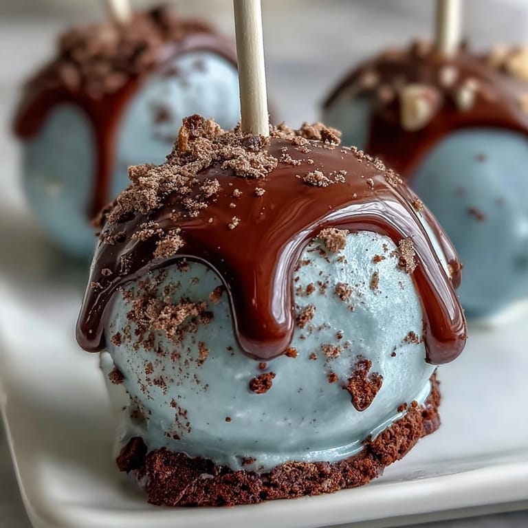 Bite-sized vanilla cake pops dipped in robins egg blue chocolate and decorated with cocoa speckles for a festive look.  