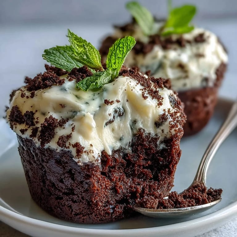 Rich chocolate brownies topped with whipped cream and crushed Oreo crumbs, decorated with edible blooms in charming flower pots.  