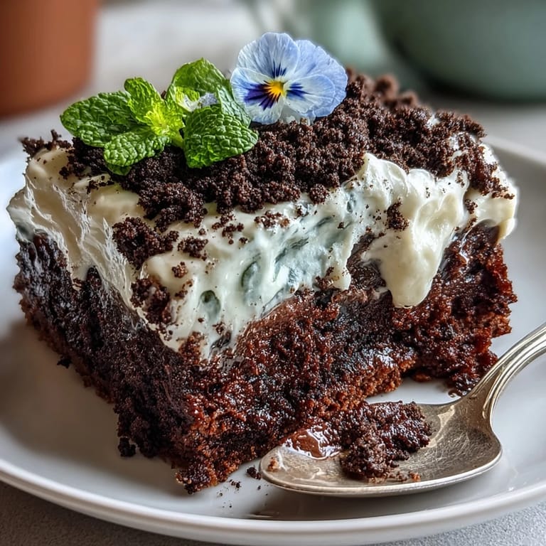 Decadent homemade brownies with creamy frosting and crunchy Oreo "soil," served in mini flower pots and adorned with edible flowers.